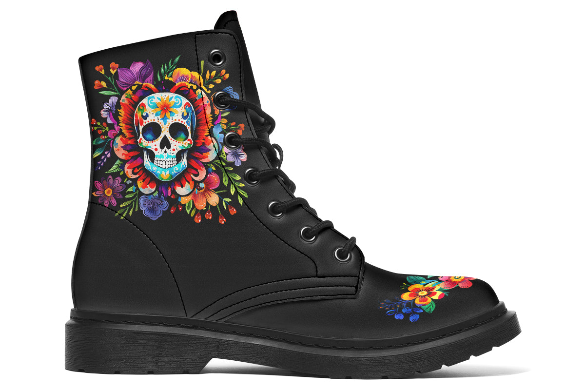 Black boots with a sugar skull design on each side, with a floral and dotted pattern on the skull and different colours flowers coming out from behind the skull. The toes of the boots feature a matching flower design.