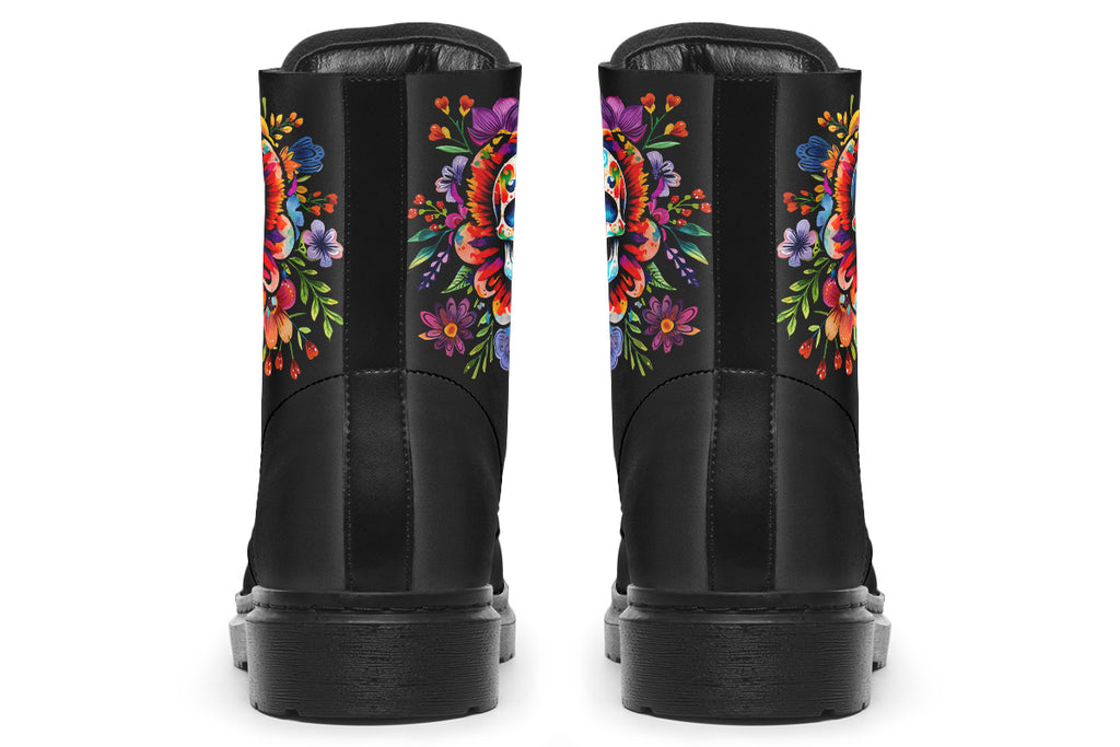 Black boots with a sugar skull design on each side, with a floral and dotted pattern on the skull and different colours flowers coming out from behind the skull. The toes of the boots feature a matching flower design.