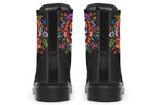 Black boots with a sugar skull design on each side, with a floral and dotted pattern on the skull and different colours flowers coming out from behind the skull. The toes of the boots feature a matching flower design.