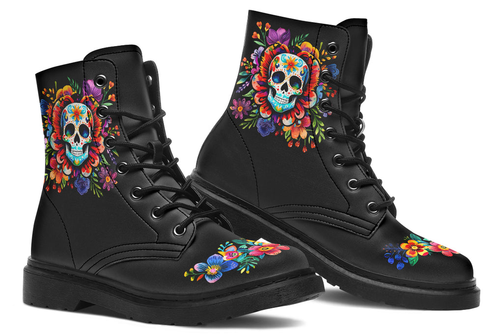 Black boots with a sugar skull design on each side, with a floral and dotted pattern on the skull and different colours flowers coming out from behind the skull. The toes of the boots feature a matching flower design.