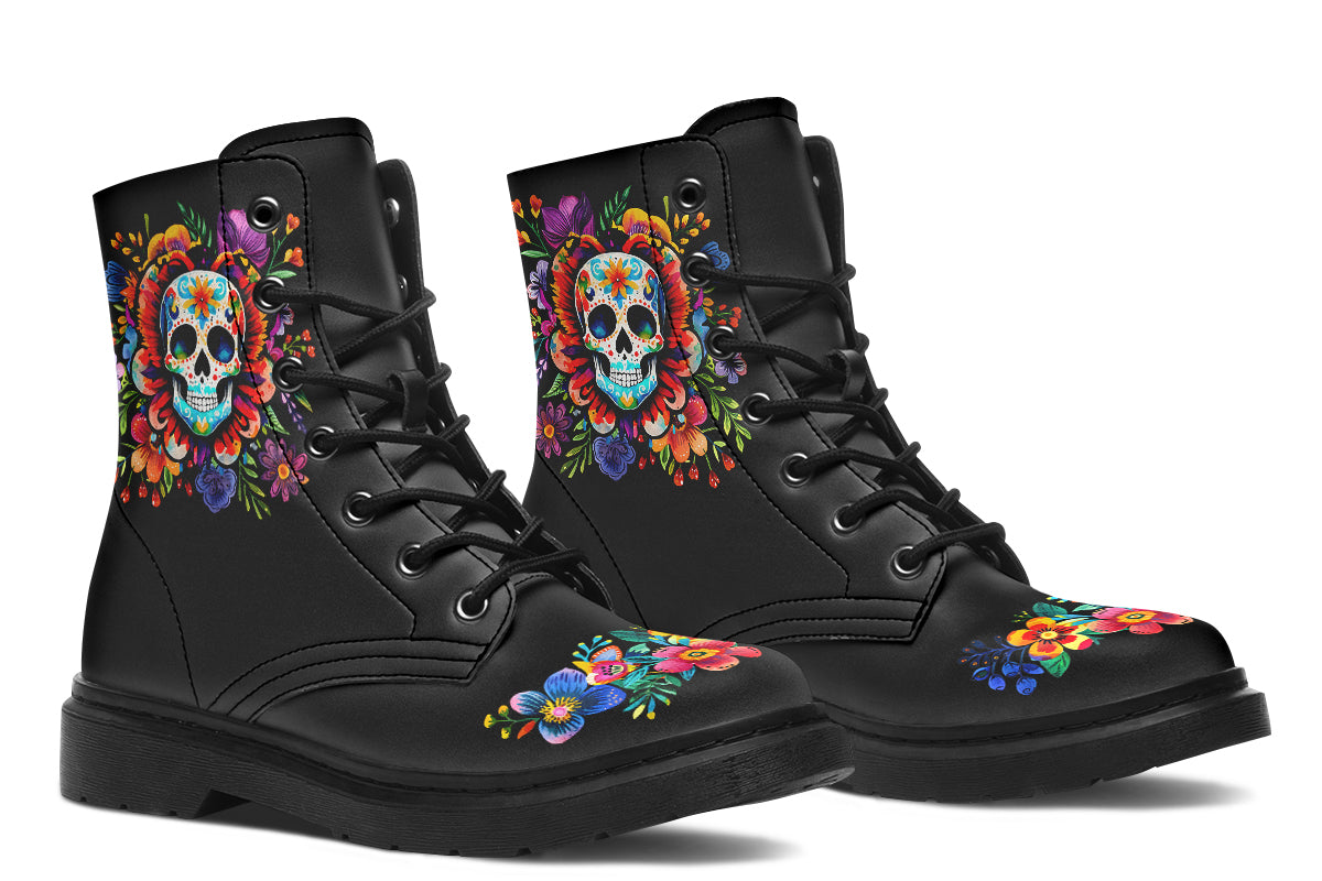 Black boots with a sugar skull design on each side, with a floral and dotted pattern on the skull and different colours flowers coming out from behind the skull. The toes of the boots feature a matching flower design.
