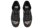 Black boots with a sugar skull design on each side, with a floral and dotted pattern on the skull and different colours flowers coming out from behind the skull. The toes of the boots feature a matching flower design.