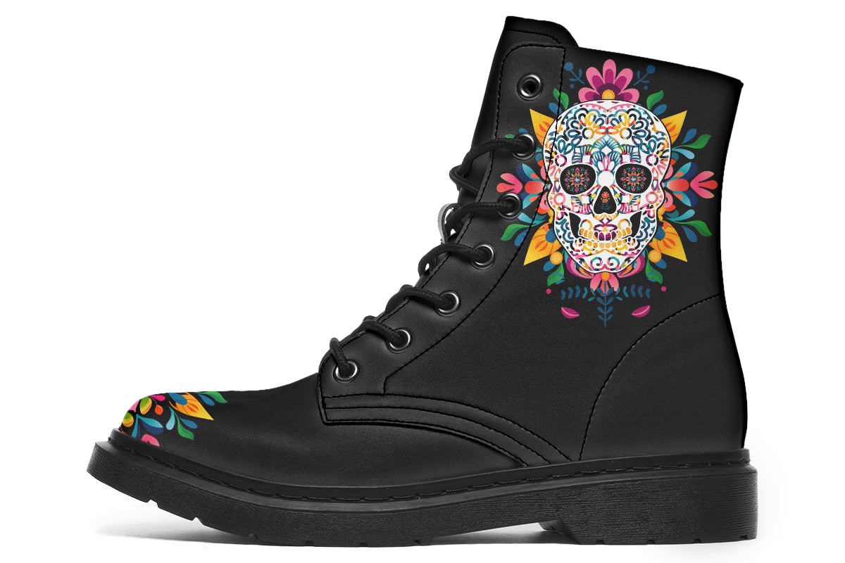 Black boots with a sugar skull design on each side, with a rainbow pattern on the skull and different colours flowers coming out from behind the skull. The toes of the boots feature a matching flower design.