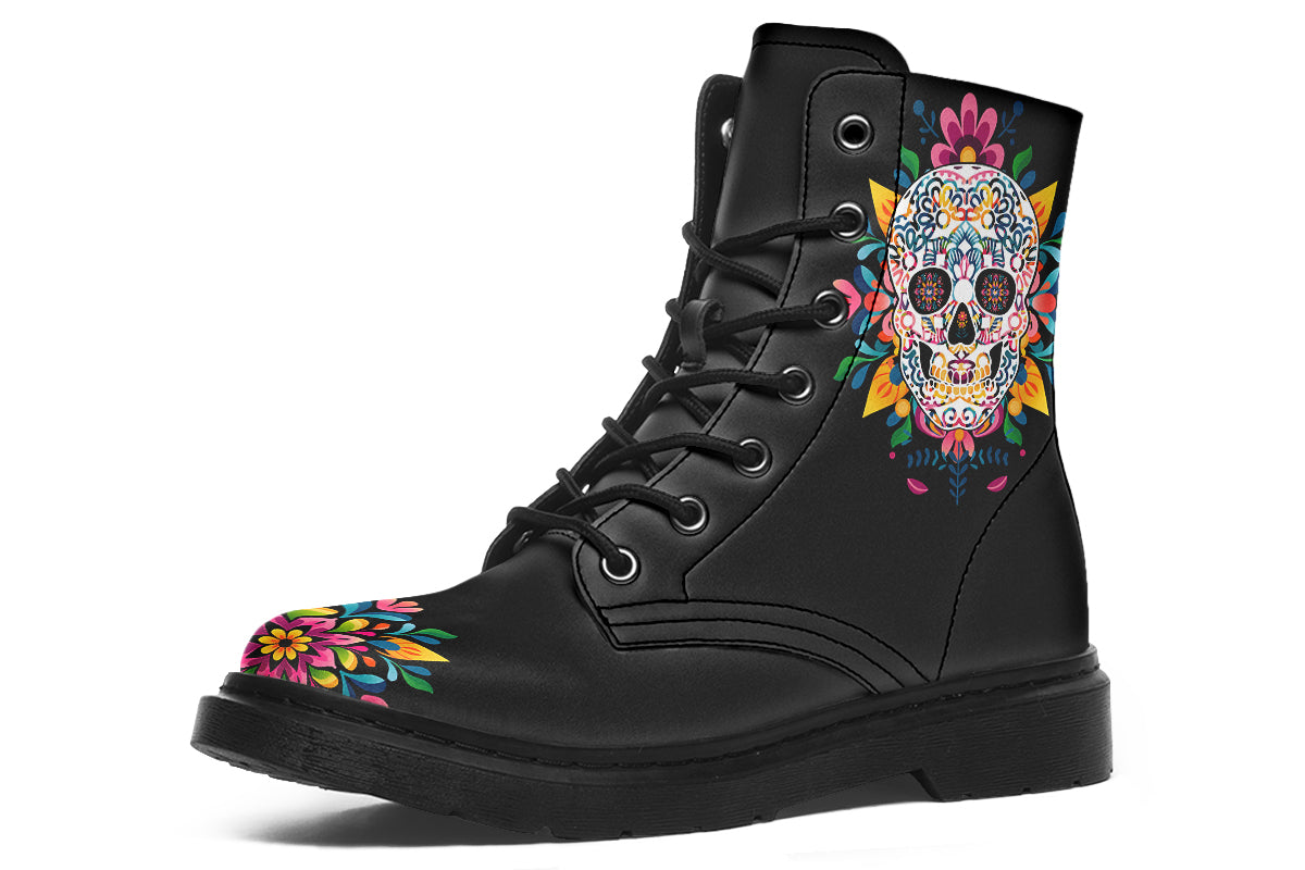 Black boots with a sugar skull design on each side, with a rainbow pattern on the skull and different colours flowers coming out from behind the skull. The toes of the boots feature a matching flower design.