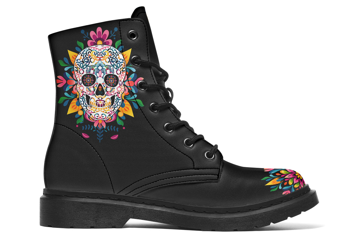 Black boots with a sugar skull design on each side, with a rainbow pattern on the skull and different colours flowers coming out from behind the skull. The toes of the boots feature a matching flower design.