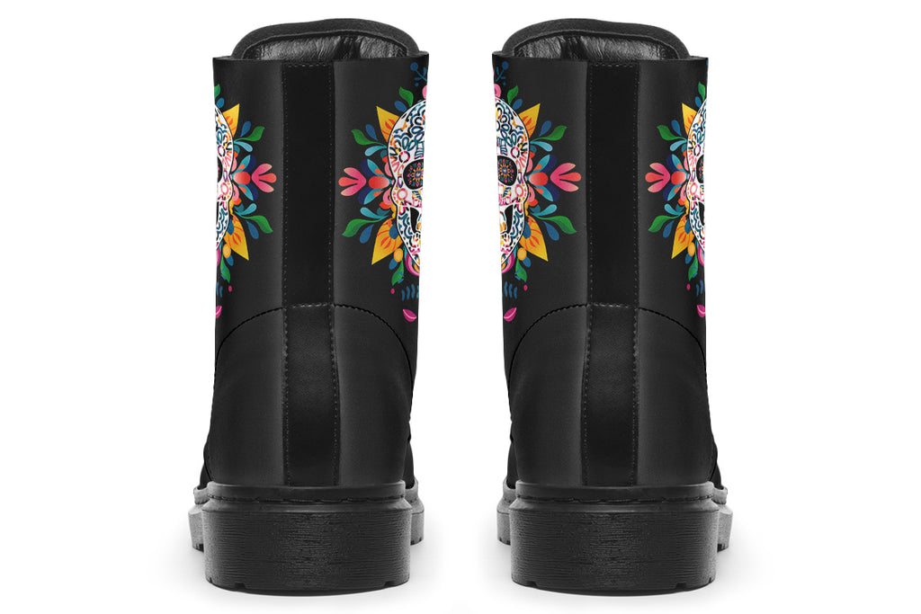 Black boots with a sugar skull design on each side, with a rainbow pattern on the skull and different colours flowers coming out from behind the skull. The toes of the boots feature a matching flower design.