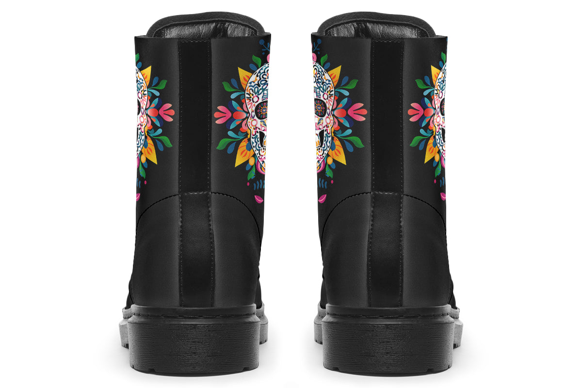 Black boots with a sugar skull design on each side, with a rainbow pattern on the skull and different colours flowers coming out from behind the skull. The toes of the boots feature a matching flower design.