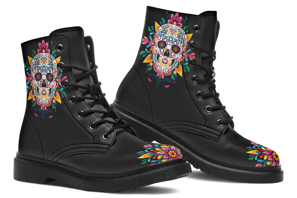Black boots with a sugar skull design on each side, with a rainbow pattern on the skull and different colours flowers coming out from behind the skull. The toes of the boots feature a matching flower design.