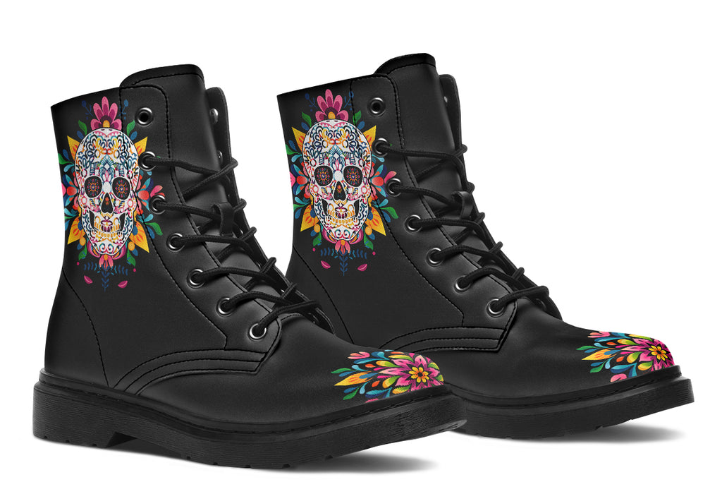 Black boots with a sugar skull design on each side, with a rainbow pattern on the skull and different colours flowers coming out from behind the skull. The toes of the boots feature a matching flower design.