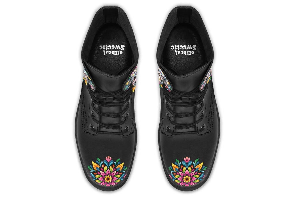Black boots with a sugar skull design on each side, with a rainbow pattern on the skull and different colours flowers coming out from behind the skull. The toes of the boots feature a matching flower design.