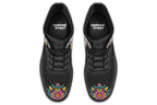 Black boots with a sugar skull design on each side, with a rainbow pattern on the skull and different colours flowers coming out from behind the skull. The toes of the boots feature a matching flower design.