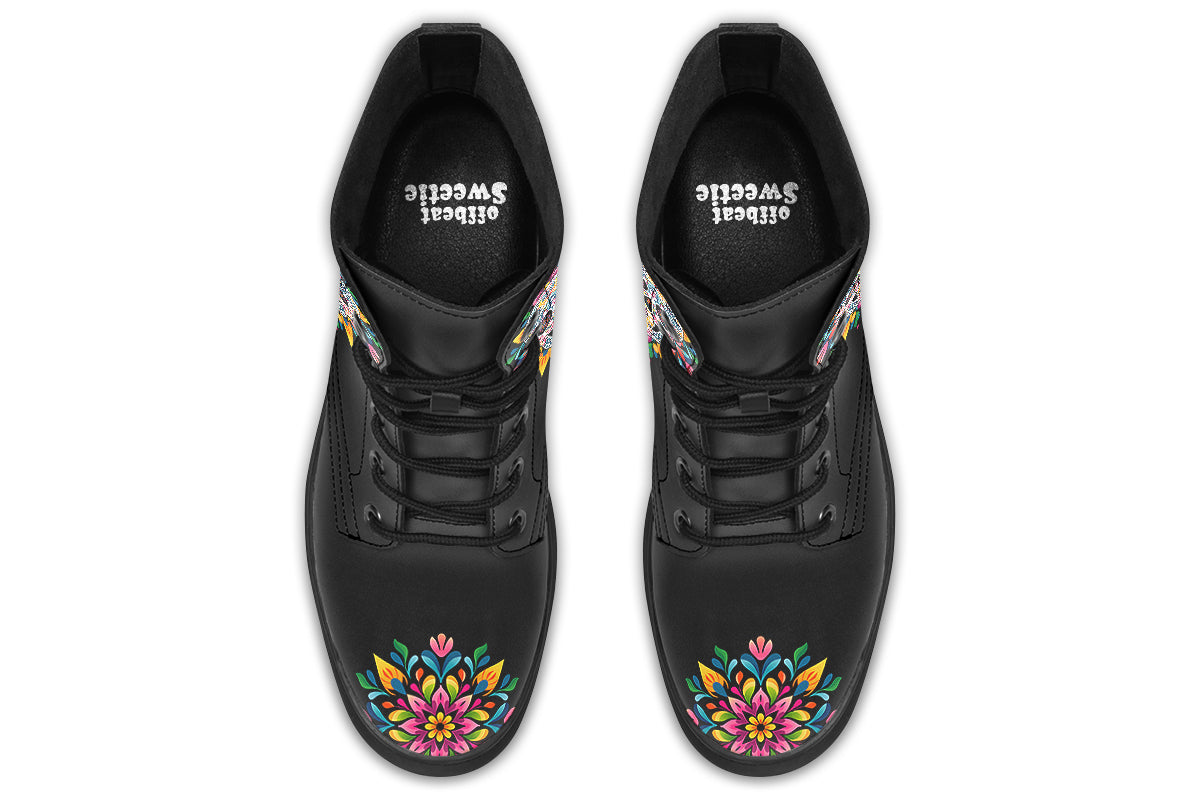 Black boots with a sugar skull design on each side, with a rainbow pattern on the skull and different colours flowers coming out from behind the skull. The toes of the boots feature a matching flower design.