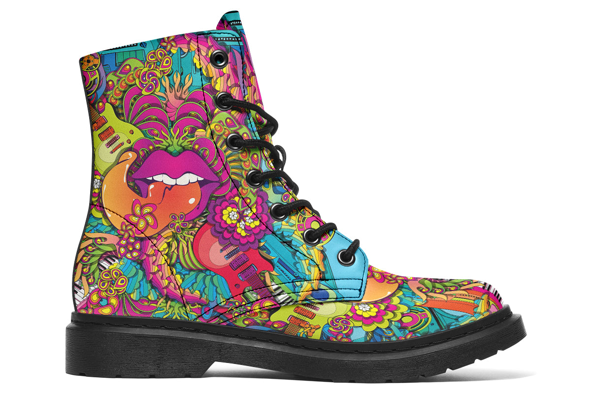 Vibrant, colourful mismatched boots in a design that’s reminiscent of a midcentury psychedelic album cover. The right boot features a peace sign with a flower-patterned guitar in it, surrounded by colourful flowers, a second guitar and other decorative patterns. The left boot features pink lips with a long tongue coming out of them which almost looks like it is licking the guitar next to it. The design has another guitar down the bottom and a busy pattern of colourful florals and swirls.
