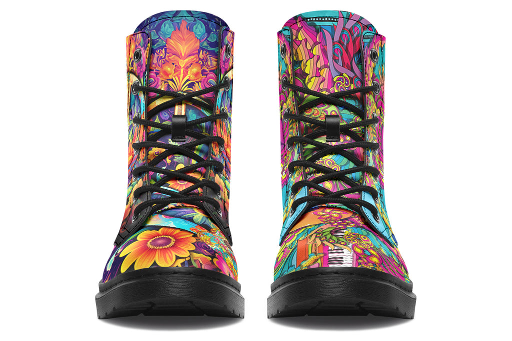 Vibrant, colourful mismatched boots in a design that’s reminiscent of a midcentury psychedelic album cover. The right boot features a peace sign with a flower-patterned guitar in it, surrounded by colourful flowers, a second guitar and other decorative patterns. The left boot features pink lips with a long tongue coming out of them which almost looks like it is licking the guitar next to it. The design has another guitar down the bottom and a busy pattern of colourful florals and swirls.