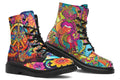 Vibrant, colourful mismatched boots in a design that’s reminiscent of a midcentury psychedelic album cover. The right boot features a peace sign with a flower-patterned guitar in it, surrounded by colourful flowers, a second guitar and other decorative patterns. The left boot features pink lips with a long tongue coming out of them which almost looks like it is licking the guitar next to it. The design has another guitar down the bottom and a busy pattern of colourful florals and swirls.