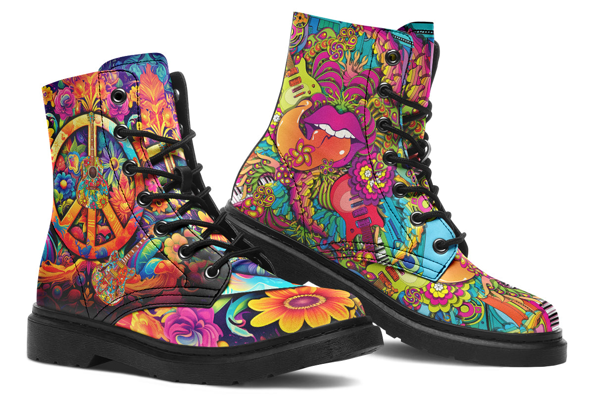 Vibrant, colourful mismatched boots in a design that’s reminiscent of a midcentury psychedelic album cover. The right boot features a peace sign with a flower-patterned guitar in it, surrounded by colourful flowers, a second guitar and other decorative patterns. The left boot features pink lips with a long tongue coming out of them which almost looks like it is licking the guitar next to it. The design has another guitar down the bottom and a busy pattern of colourful florals and swirls.