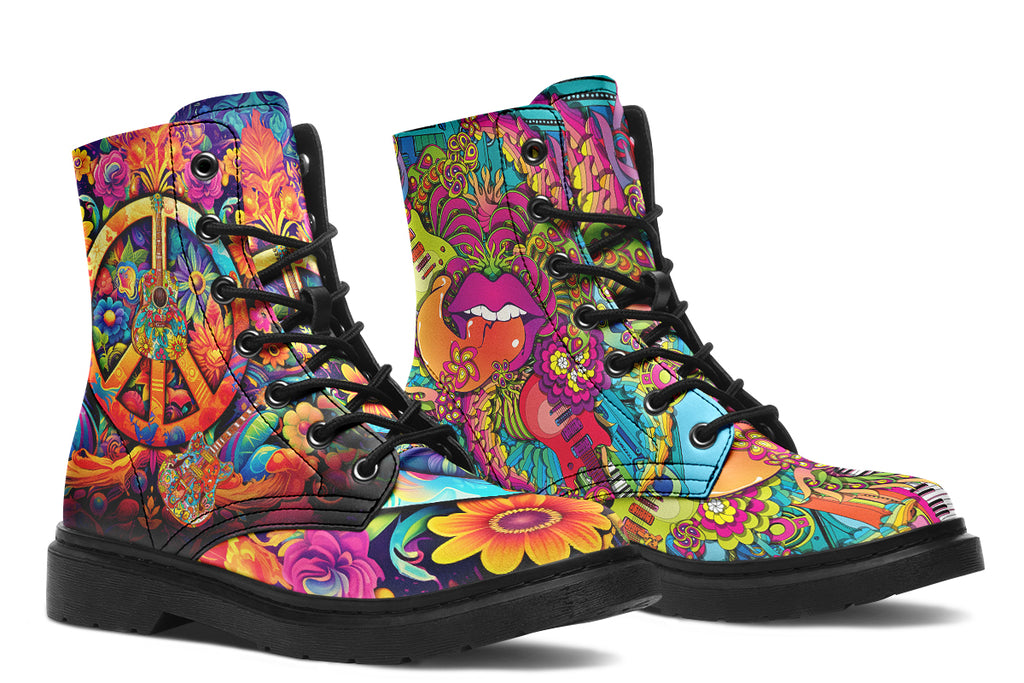 Vibrant, colourful mismatched boots in a design that’s reminiscent of a midcentury psychedelic album cover. The right boot features a peace sign with a flower-patterned guitar in it, surrounded by colourful flowers, a second guitar and other decorative patterns. The left boot features pink lips with a long tongue coming out of them which almost looks like it is licking the guitar next to it. The design has another guitar down the bottom and a busy pattern of colourful florals and swirls.
