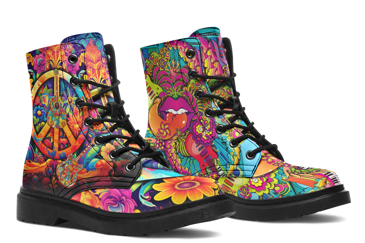 Vibrant, colourful mismatched boots in a design that’s reminiscent of a midcentury psychedelic album cover. The right boot features a peace sign with a flower-patterned guitar in it, surrounded by colourful flowers, a second guitar and other decorative patterns. The left boot features pink lips with a long tongue coming out of them which almost looks like it is licking the guitar next to it. The design has another guitar down the bottom and a busy pattern of colourful florals and swirls.