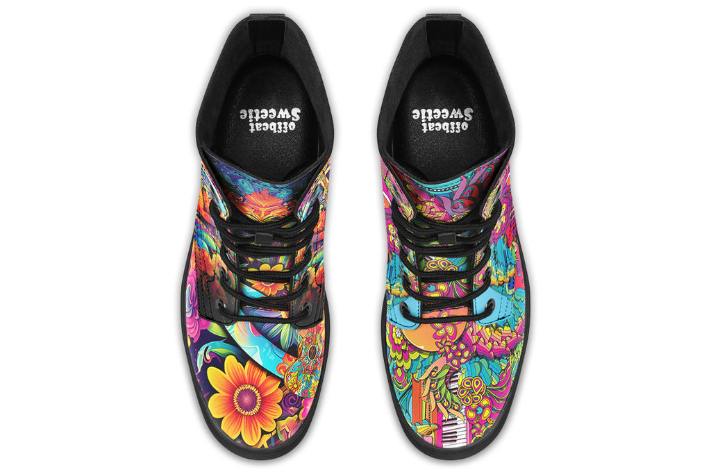 Vibrant, colourful mismatched boots in a design that’s reminiscent of a midcentury psychedelic album cover. The right boot features a peace sign with a flower-patterned guitar in it, surrounded by colourful flowers, a second guitar and other decorative patterns. The left boot features pink lips with a long tongue coming out of them which almost looks like it is licking the guitar next to it. The design has another guitar down the bottom and a busy pattern of colourful florals and swirls.