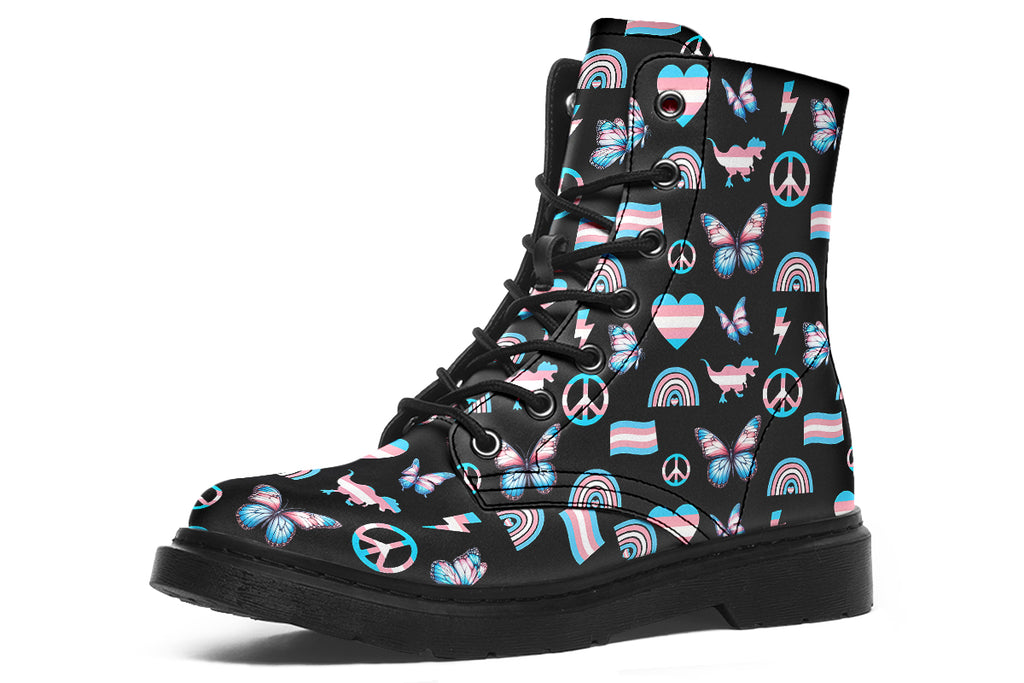 Black boots featuring a pattern of various icons in the trans flag colours, such as hearts, rainbows, peace signs, flags, butterflies and dinosaurs.
