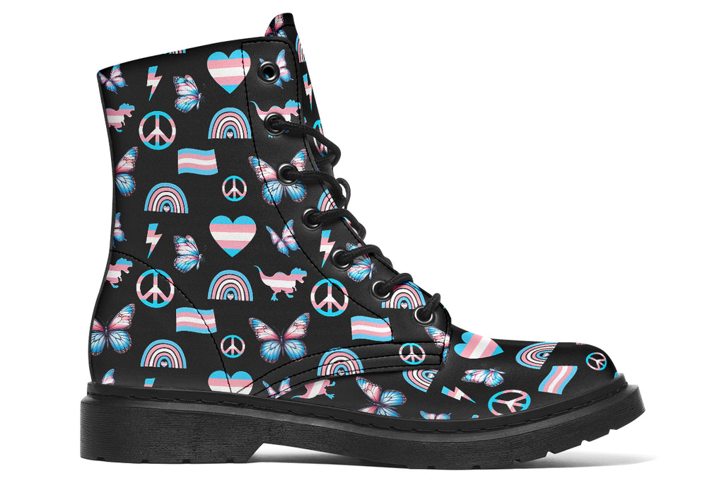 Black boots featuring a pattern of various icons in the trans flag colours, such as hearts, rainbows, peace signs, flags, butterflies and dinosaurs.