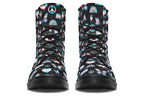 Black boots featuring a pattern of various icons in the trans flag colours, such as hearts, rainbows, peace signs, flags, butterflies and dinosaurs.