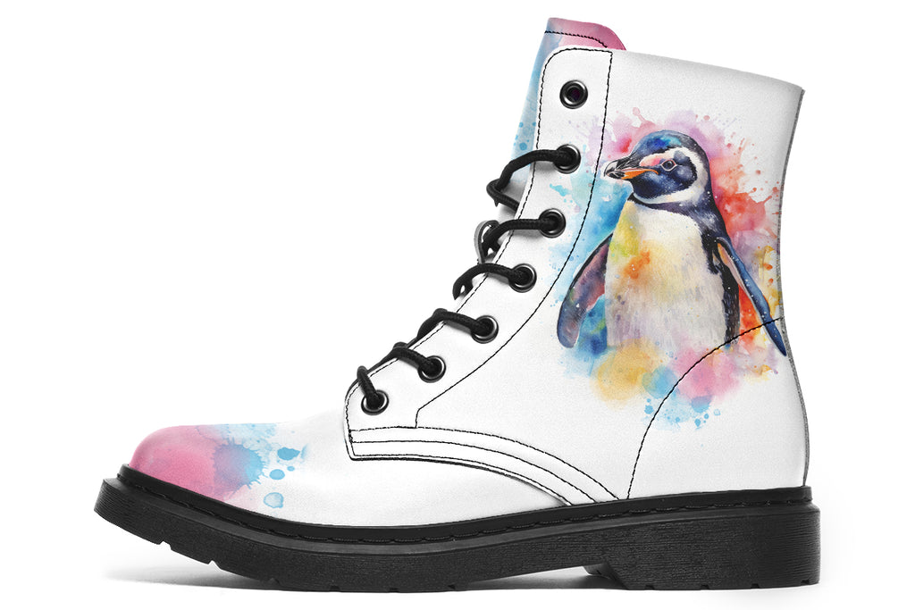 White boots with an image of a penguin on the sides, in the style of a watercolour painting with various colours splashed behind the penguin and on the toes and tongue of the boots