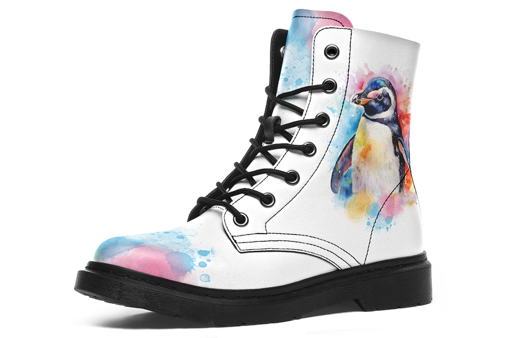 White boots with an image of a penguin on the sides, in the style of a watercolour painting with various colours splashed behind the penguin and on the toes and tongue of the boots