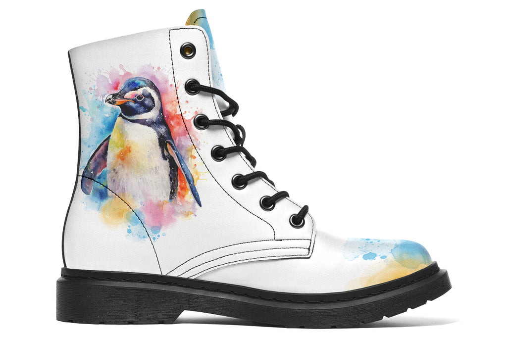 White boots with an image of a penguin on the sides, in the style of a watercolour painting with various colours splashed behind the penguin and on the toes and tongue of the boots