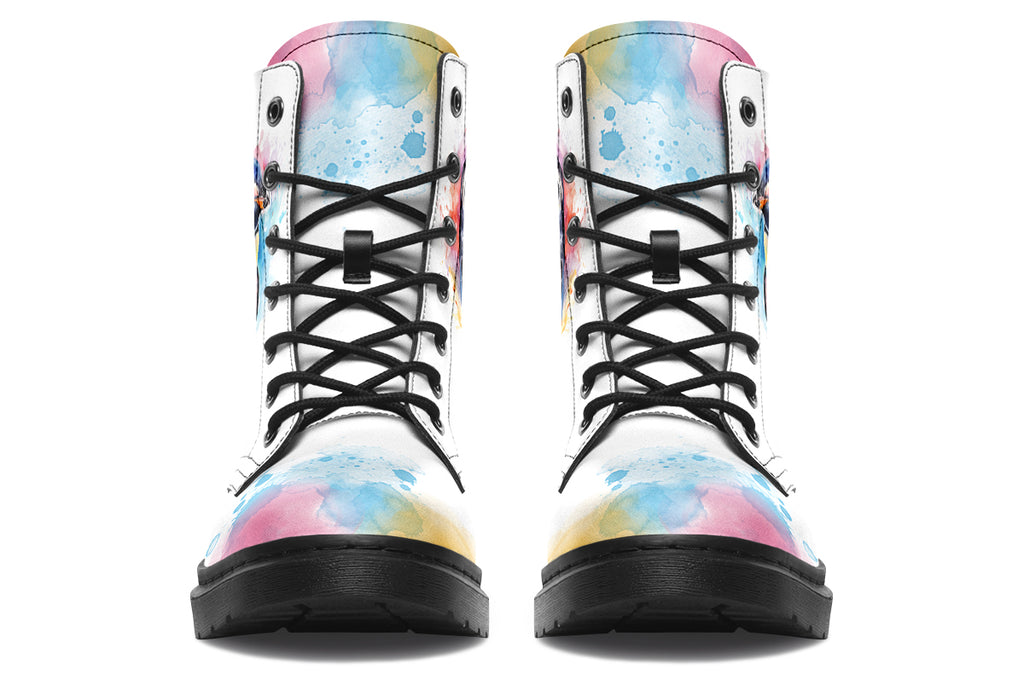 White boots with an image of a penguin on the sides, in the style of a watercolour painting with various colours splashed behind the penguin and on the toes and tongue of the boots