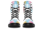 White boots with an image of a penguin on the sides, in the style of a watercolour painting with various colours splashed behind the penguin and on the toes and tongue of the boots