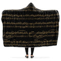 Hooded blanket with gold musical notes on black background