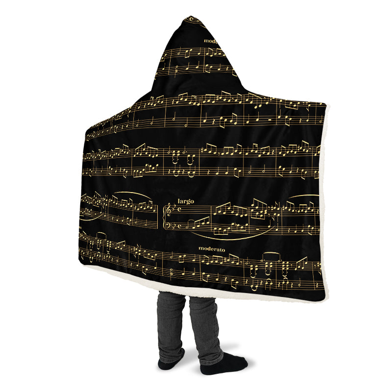 Hooded blanket with gold musical notes on black background