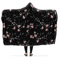 Hooded blanket with pink floral patterns on a black background