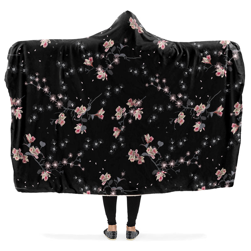 Hooded blanket with pink floral patterns on a black background