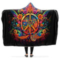 Colorful hooded blanket with peace symbol, guitar and floral designs on a black background