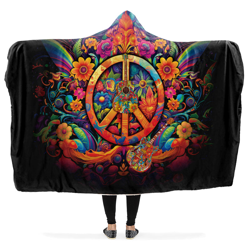 Colorful hooded blanket with peace symbol, guitar and floral designs on a black background
