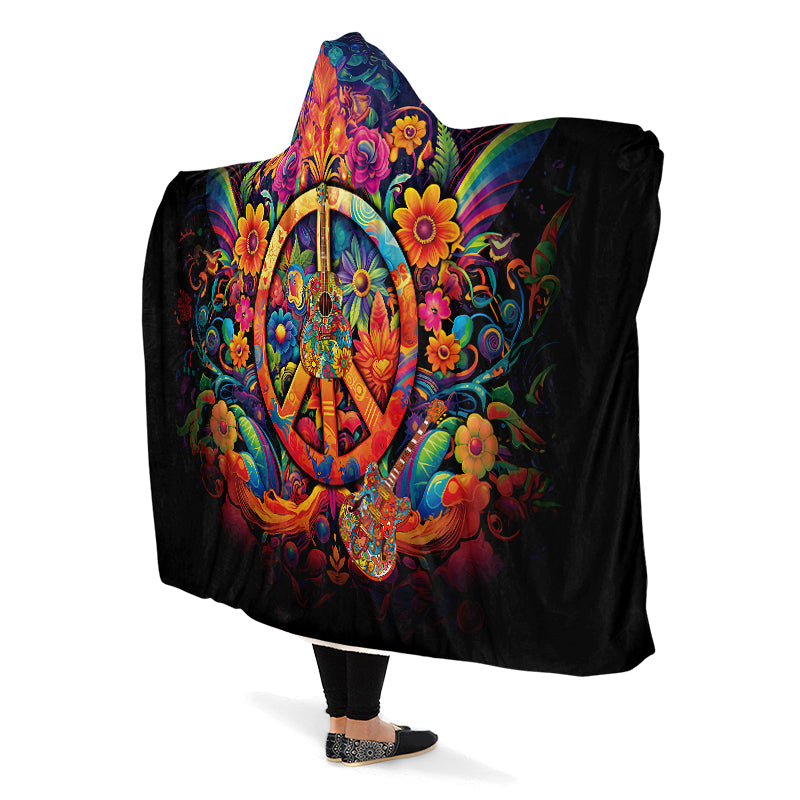 Colorful hooded blanket with peace symbol, guitar and floral designs on a black background