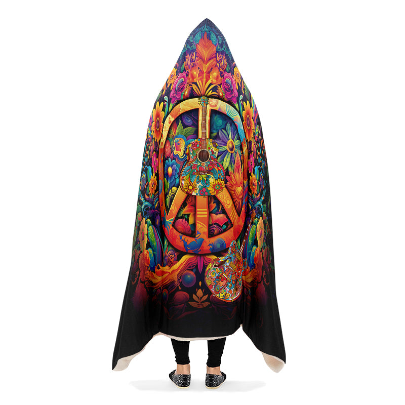 Colorful hooded blanket with peace symbol, guitar and floral designs on a black background