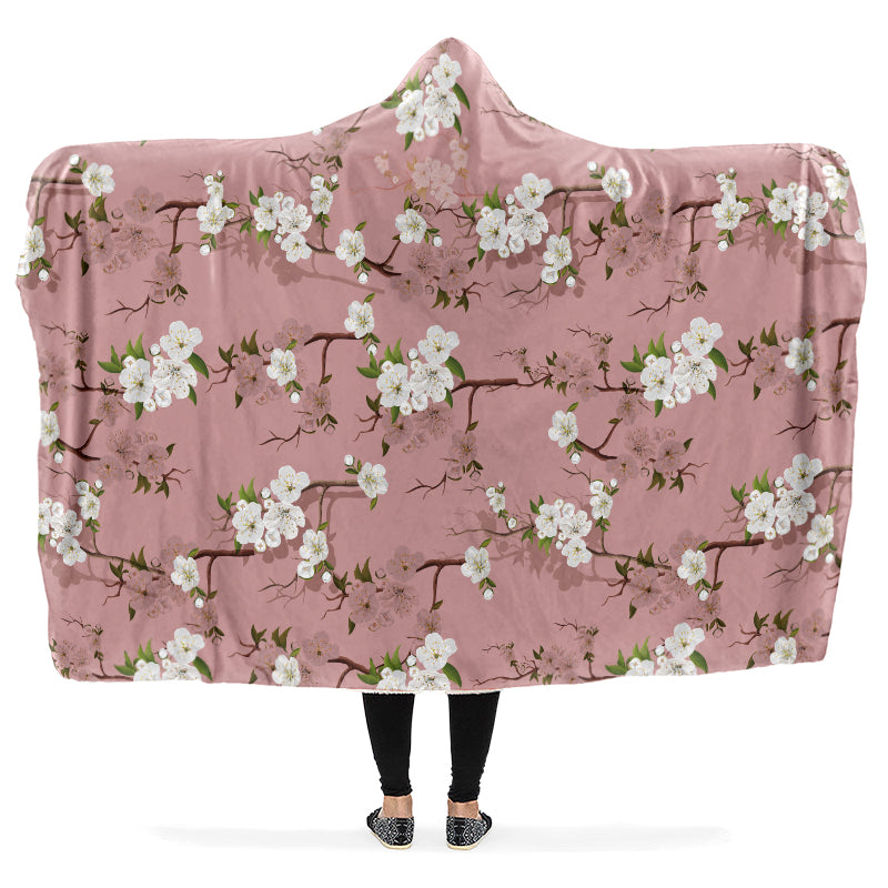 Hooded blanket with a white floral pattern on a pink background