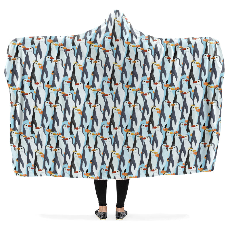 Hooded blanket with penguin pattern on a light blue background