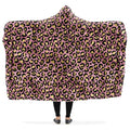 Hooded blanket with gold leopard print on a pink background