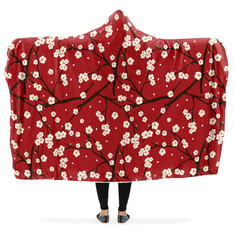 Hooded blanket with a white floral pattern on a red background