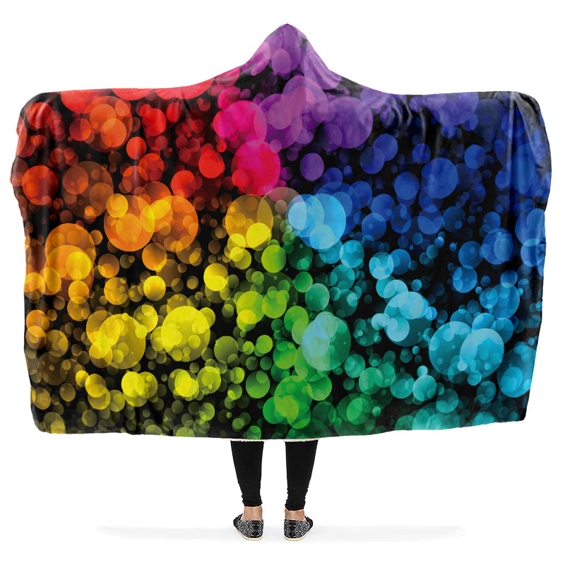 Colorful hooded blanket with a vibrant, rainbow bubble design on a black background