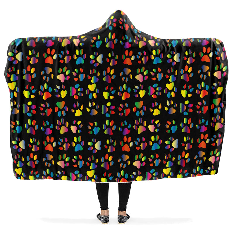 Hooded blanket with colorful paw print pattern on a black background