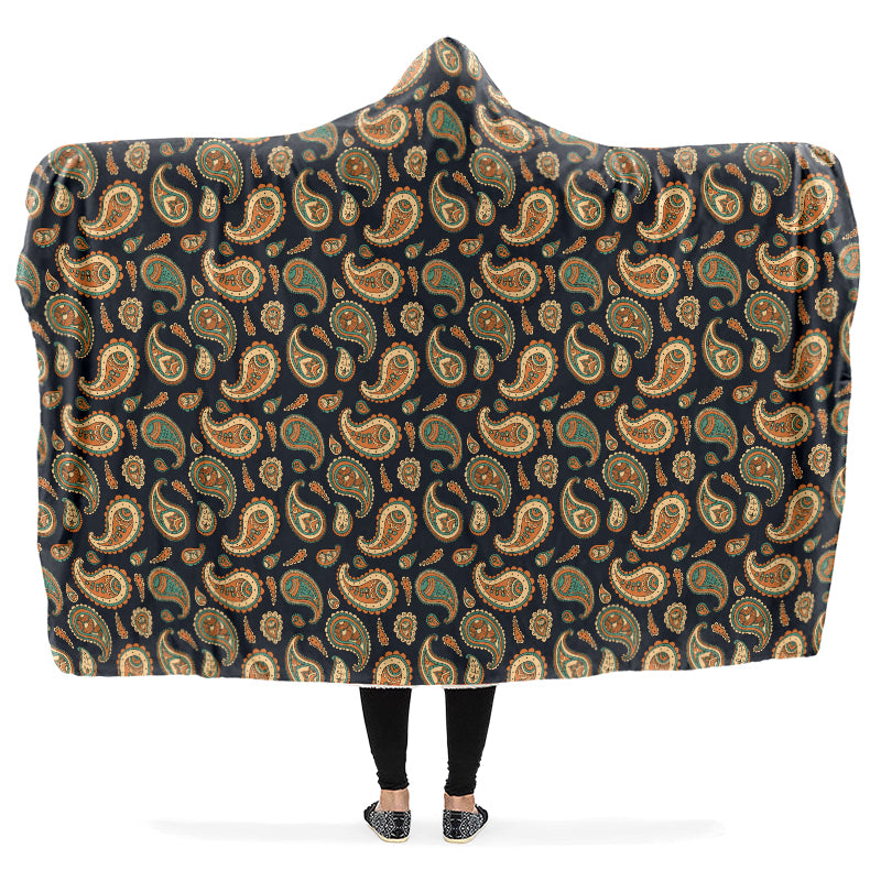 Hooded blanket with a retro-inspired paisley pattern in brown, green and burnt orange.