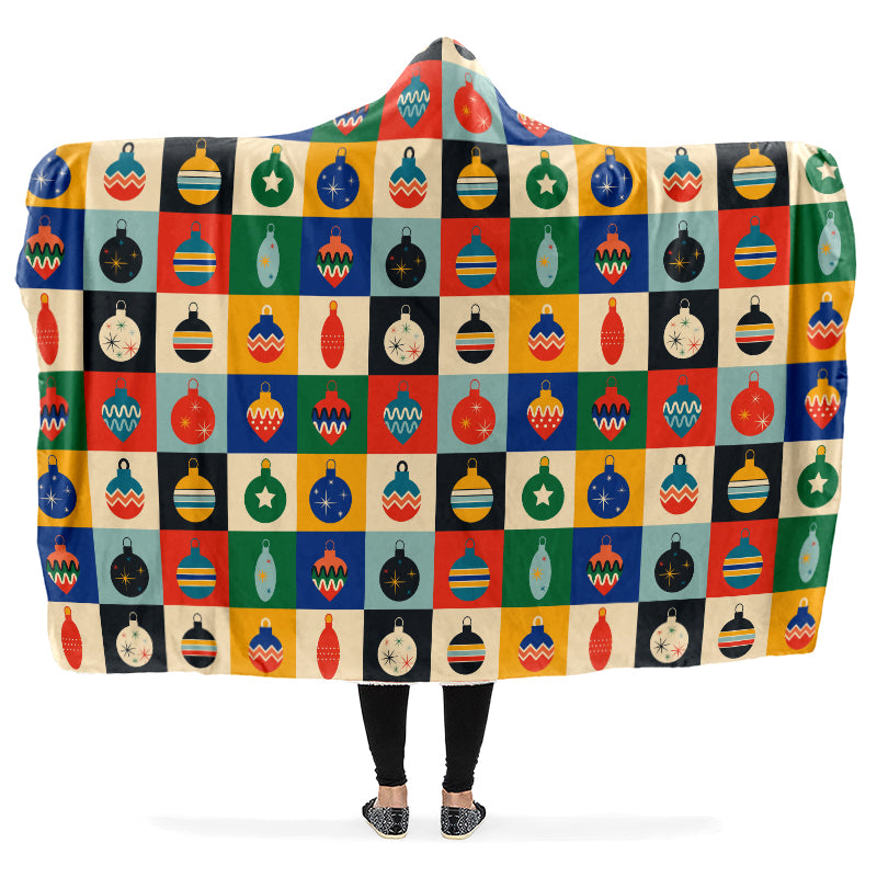 Hooded blanket with colorful geometric Christmas bauble pattern.