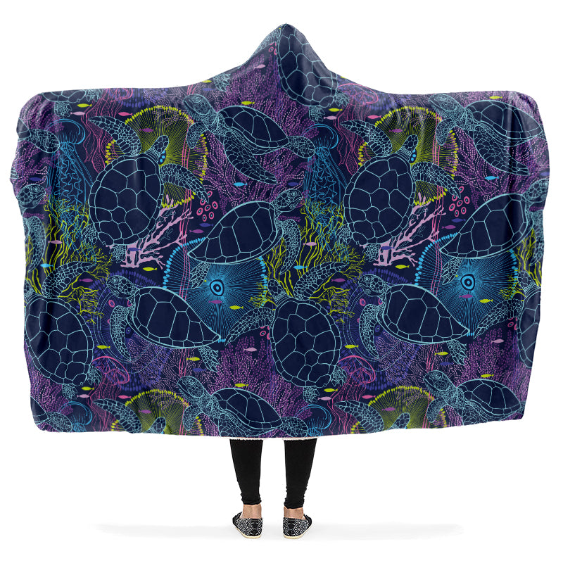 Hooded blanket with blue and green turtle pattern on a purple background