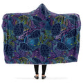 Hooded blanket with blue and green turtle pattern on a purple background