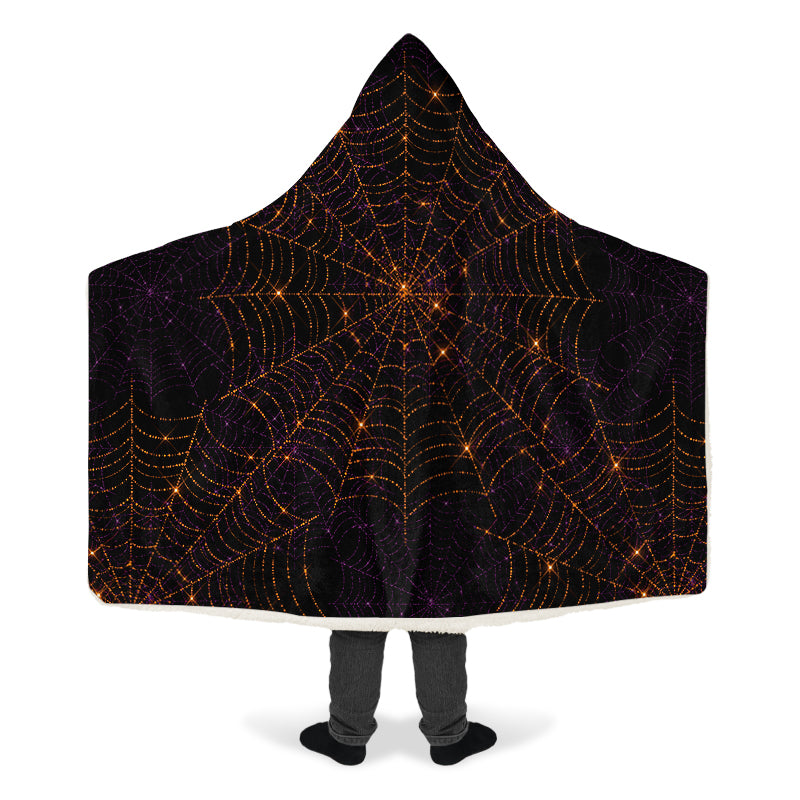 Hooded blanket with spider web design on a black background